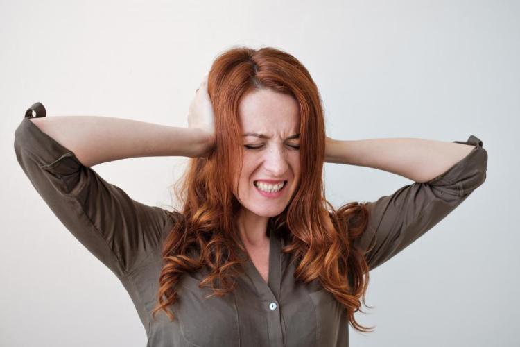 woman-with-misophonia-covering-her-ears-because-she-is-upset-by-noises